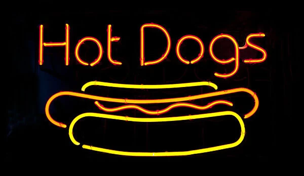 Neon hot dog sign on black background