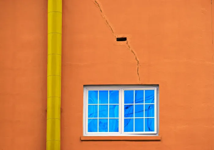 Framed Print : Neon Pipe. A color photograph of the wall to an aging commercial building