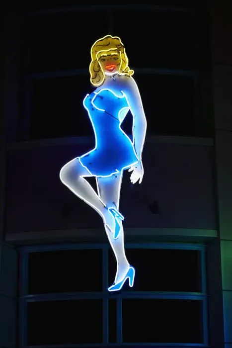 Framed Print : Neon sign of woman illuminated at night