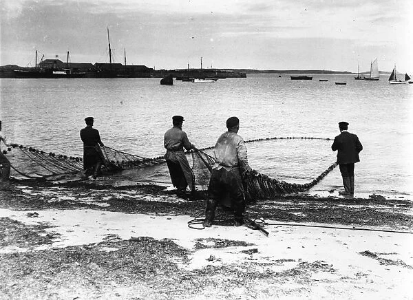 Full Nets. circa 1900: Fishermen bringing in the catch in the Scilly Isles