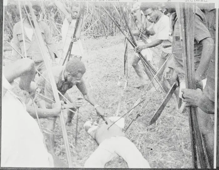 Framed Print : New Guinea Rebels with Weapons Surrounding Slain Victim Framed Print : New Guinea Rebels with Weapons Surrounding Slain Victim