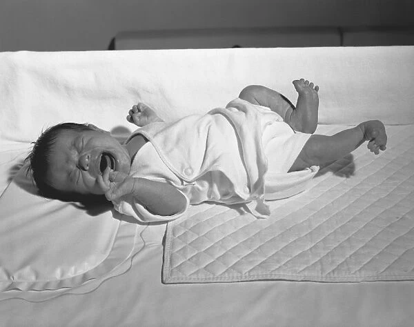 Newborn (0-3 months) lying in crib, crying, (B&W)
