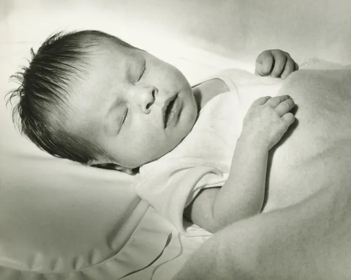 Framed Print : Newborn (0-3 months) sleeping in crib, (B&W) Framed Print : Newborn (0-3 months) sleeping in crib, (B&W)
