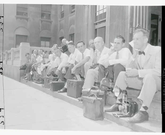 Framed Print : News Photographers Resting on Sidewalk Framed Print : News Photographers Resting on Sidewalk