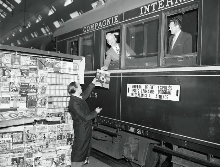 Framed Print : News Vendor Handing Magazine to Simplon-Orient Express Passenger Framed Print : News Vendor Handing Magazine to Simplon-Orient Express Passenger