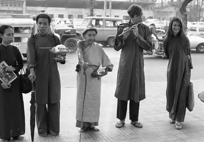 Framed Print : Nguyen Thanh Nam and John Steinbeck IV Plays Flute Outside U.S. Embassy