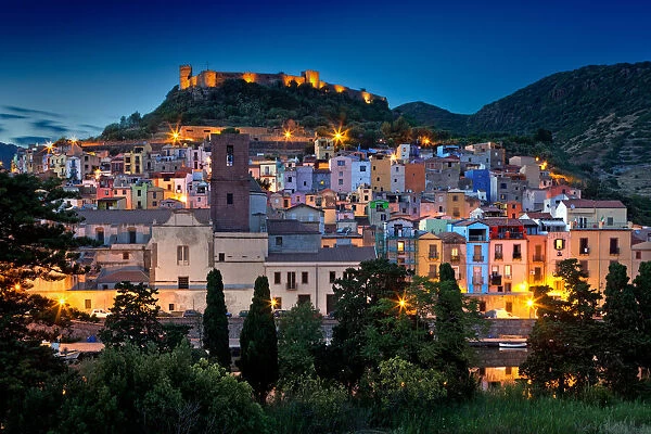 Nighttime view over the colourful town of Bosa and its medieval castle along the Temo