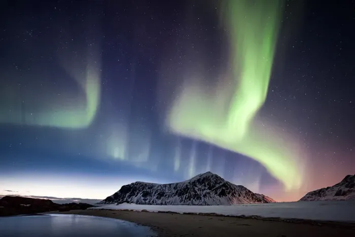 Framed Print : northern lights over a mountain on the beach