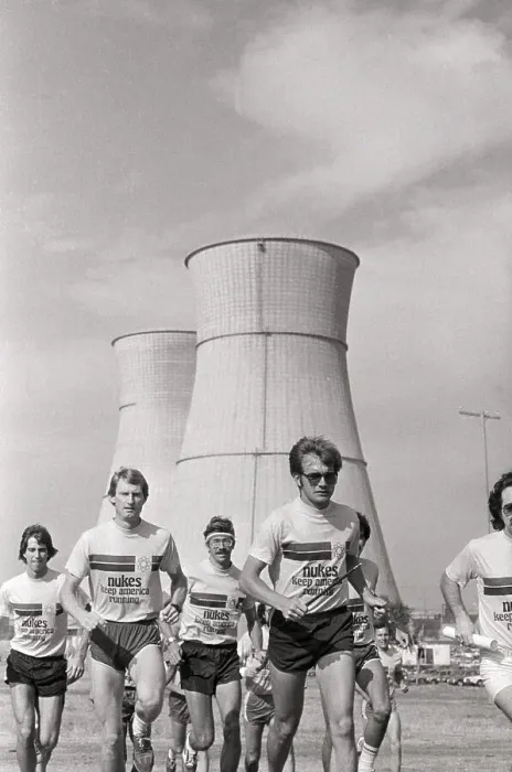 Framed Print : Nuclear Workers Running In Front / Towers