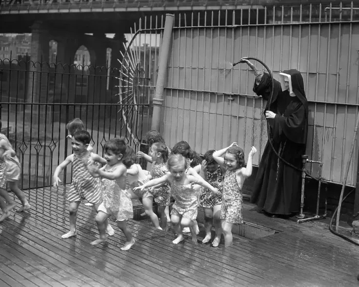 Framed Print : Nun splashing water on children Framed Print : Nun splashing water on children