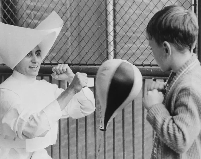 Framed Print : Nun Teaching Young Boy to Box Framed Print : Nun Teaching Young Boy to Box