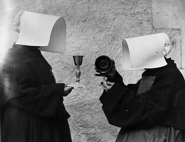 Nuns. circa 1930: Two nuns holding a calice and a religious object
