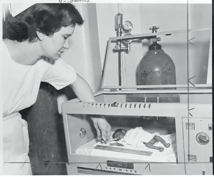 Framed Print : Nure Feeding Premature Baby