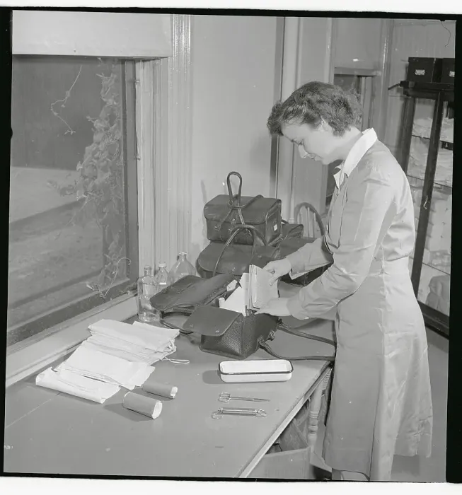 Framed Print : Nurse Checking Contents of Her Bag Framed Print : Nurse Checking Contents of Her Bag