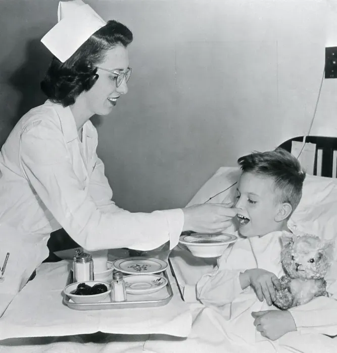 Framed Print : Nurse Feeding Boy in Bed