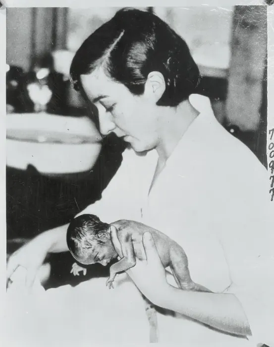 Framed Print : Nurse Holding Infant Quintuplet Framed Print : Nurse Holding Infant Quintuplet