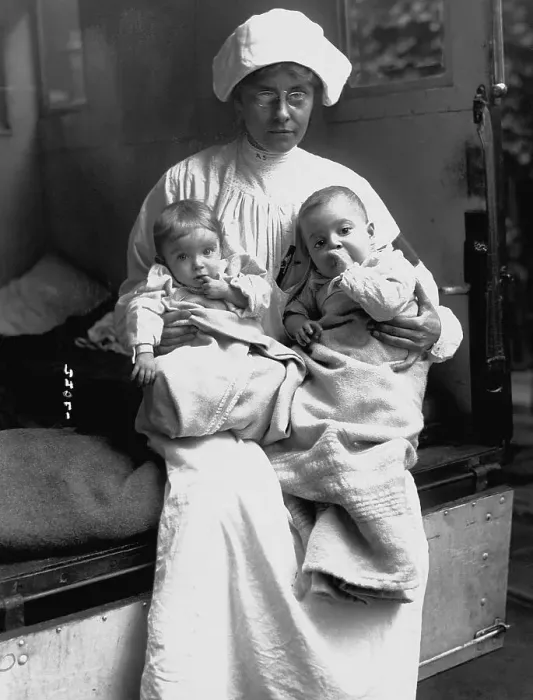Framed Print : Nurse Holding Two Infants Framed Print : Nurse Holding Two Infants
