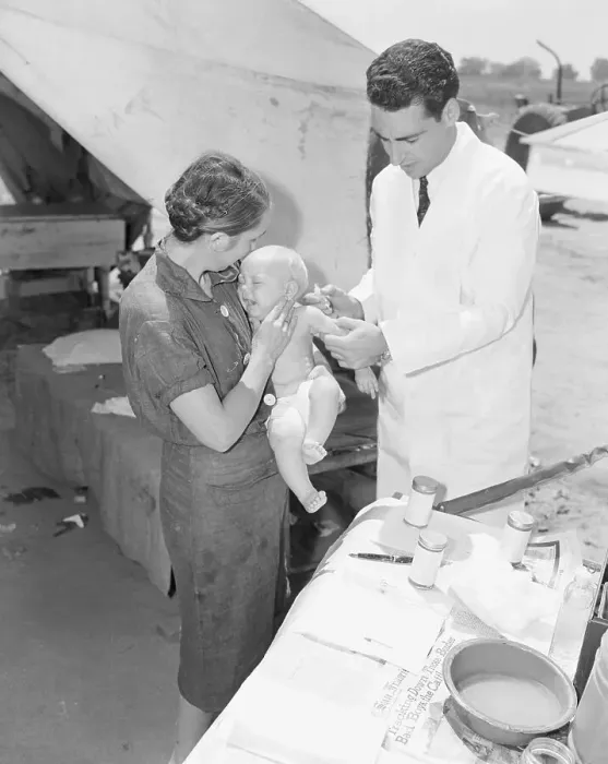 Framed Print : Nurse Holding Migrant Baby for Doctor Framed Print : Nurse Holding Migrant Baby for Doctor