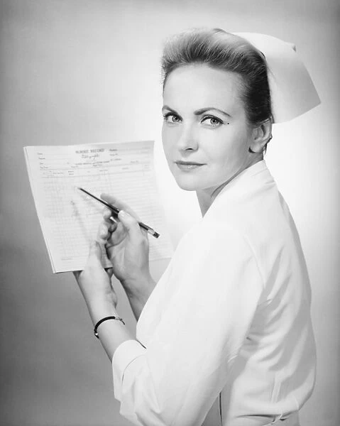 Nurse holding patients chart in studio, (B&W), portrait