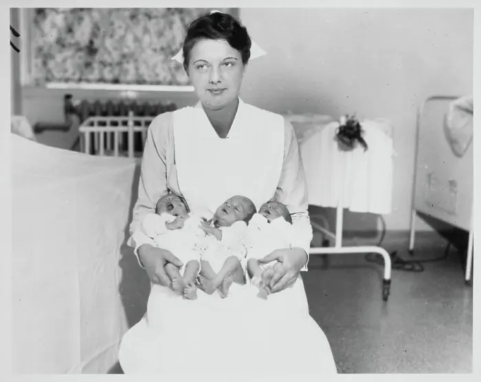 Framed Print : Nurse Holding Triplets Framed Print : Nurse Holding Triplets