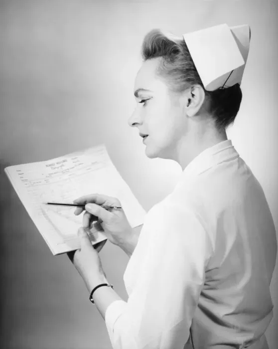 Framed Print : Nurse noting on patients chart, (B&W) Framed Print : Nurse noting on patients chart, (B&W)