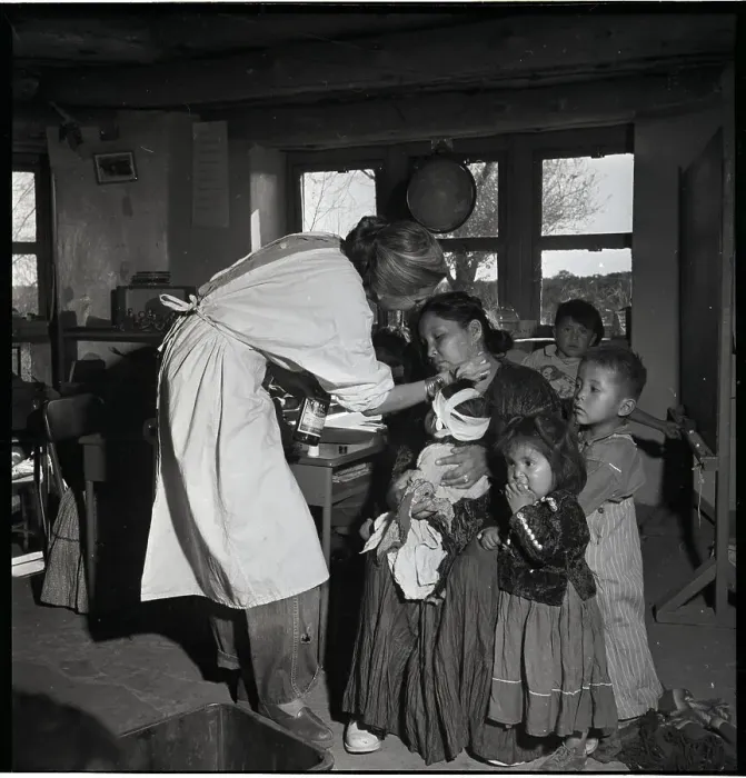 Framed Print : Nurse Treating Mother And Children Framed Print : Nurse Treating Mother And Children