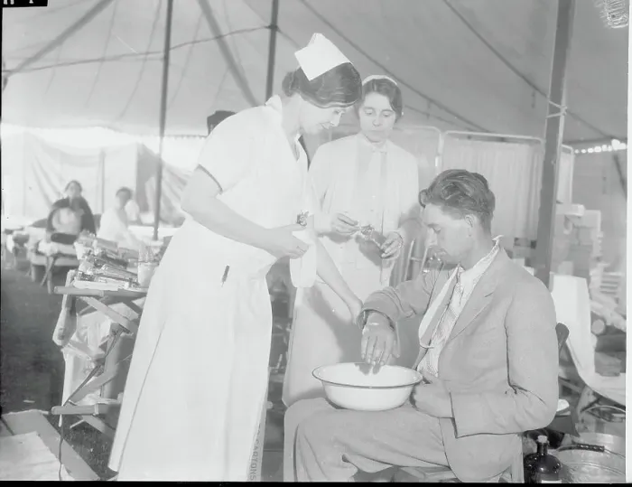 Framed Print : Nurses Tending Injured Man