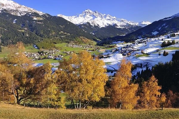 Oberhalbstein in autumn with the villages Cunter, Savognin, Parsonz, behind the snowy Piz d Err, Graubunden, Switzerland