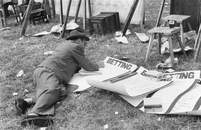 Framed Print : Odds On. 11th August 1952: A bookie at the Brighton races writing up the odds