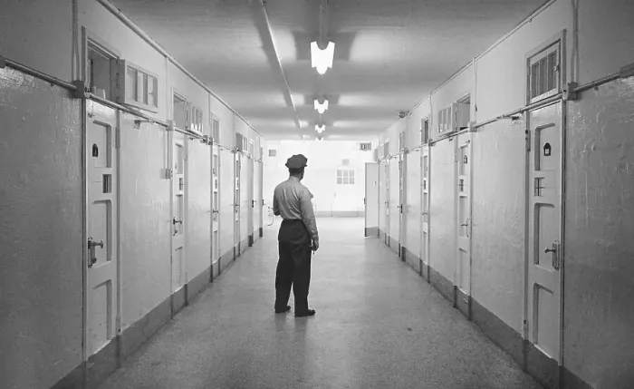 Framed Print : Officer Standing in Hallway of Prison Framed Print : Officer Standing in Hallway of Prison