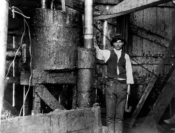 Oil Well. circa 1910: The interior of a box tower at a petrol works at
