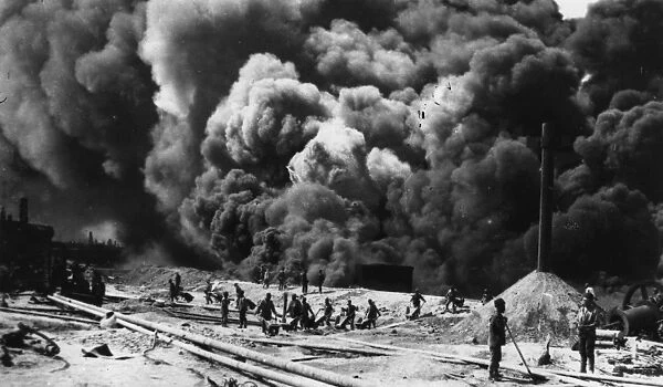 Oil Field. 1st December 1918: Men working amidst the thick smoke of the Baku oil fields