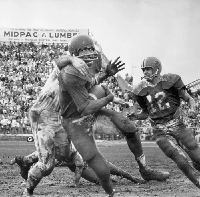 Framed Print : O.J. Simpson Tackled on Muddy Field Framed Print : O.J. Simpson Tackled on Muddy Field