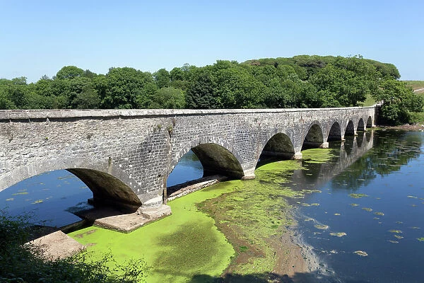 Old eight arch bridge in welsh countryside