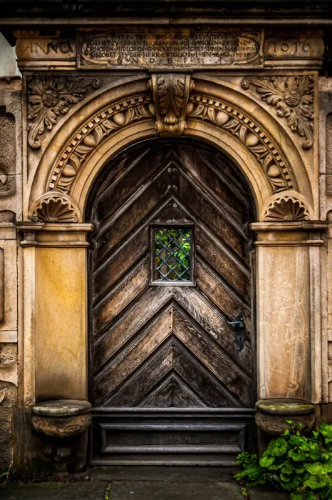 Framed Print : An old carved wooden door with an ornate frame with latin inscriptions Framed Print : An old carved wooden door with an ornate frame with latin inscriptions