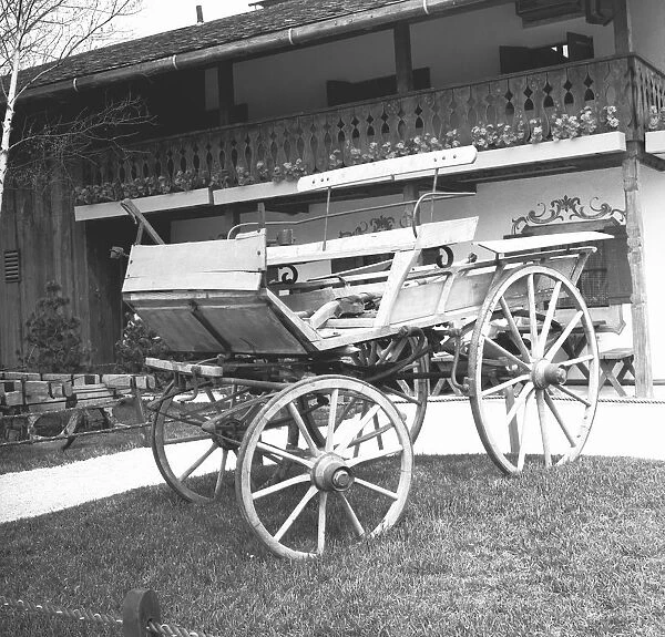 Old fashion carriage in front of house, (B&W)