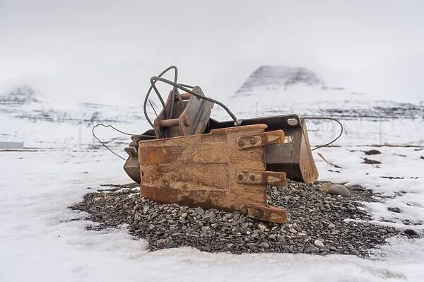 an old industrial equipment leaving on a snow ground