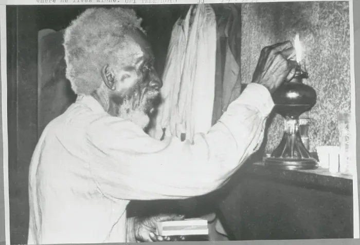 Framed Print : Old Man Lighting Oil Lamp Framed Print : Old Man Lighting Oil Lamp