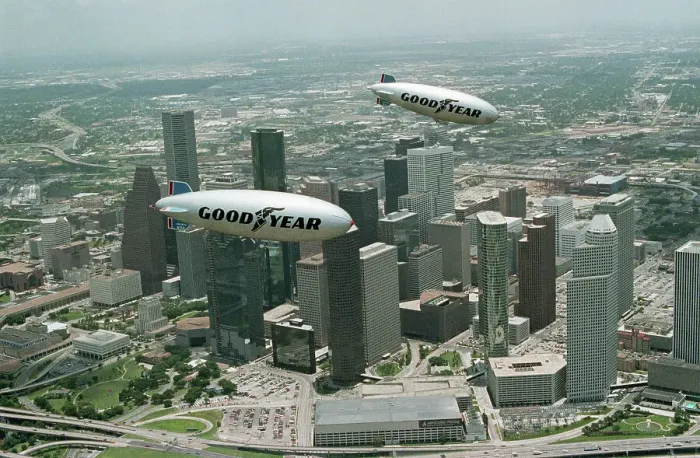 Framed Print : Old and New Goodyear Blimps Fly Above Houston