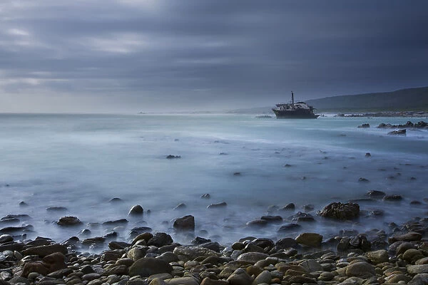 Old shipwreck long exposure on the rocks at sunset - Cape LAgulhas South Africa