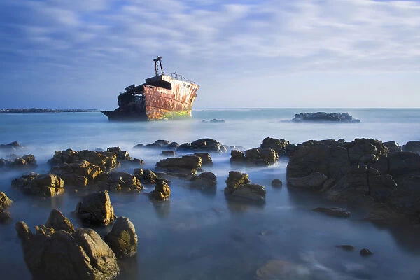 Old shipwreck long exposure on the rocks at sunset - Cape L Agulus South Africa
