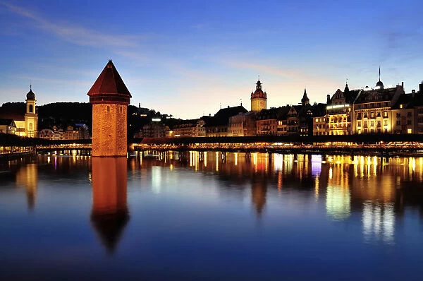 Old town of Lucerne with Kapellbrucke bridge, Wasserturm tower and the Reuss river, at dusk, Lucerne, Canton of Lucerne, Switzerland