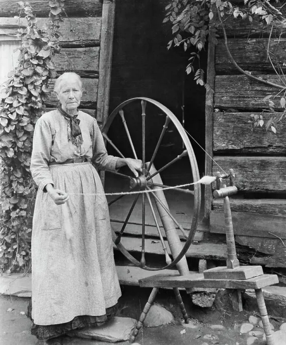 Framed Print : Old Woman At Spinning Wheel Outdoors
