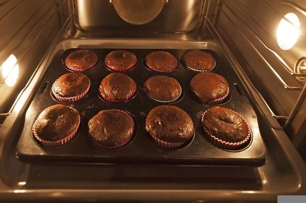 Oreo brownie cupcakes on a baking tray in the oven