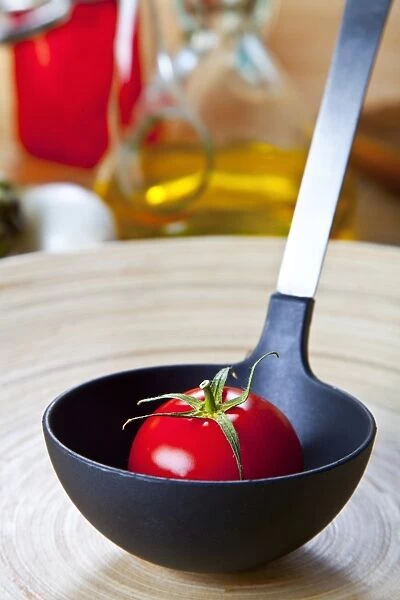 Organic tomato in a soup ladle