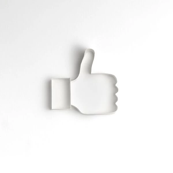 Origami. a thumbs up icon made origami style on a white backdrop