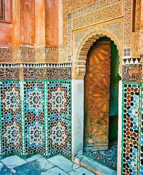 Ornate Tiled Wall and Open Wooden Door in Marrakech Morocco