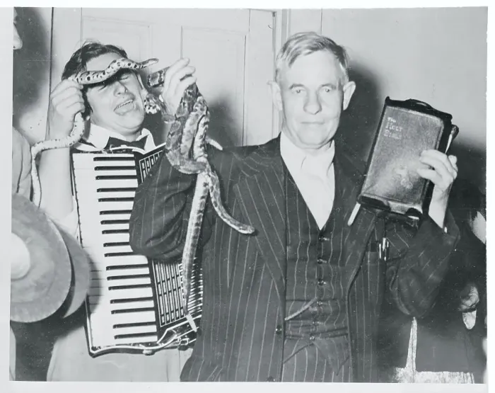 Framed Print : Oscar Hutton Holding Bible and Snakes Framed Print : Oscar Hutton Holding Bible and Snakes