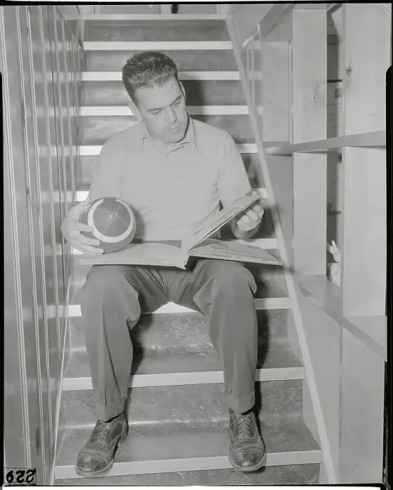 Framed Print : Otto Graham Holding Football and Reading Framed Print : Otto Graham Holding Football and Reading