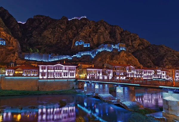 Ottoman houses on the Yesilirmak river and Castle Hill illuminated at night, Amasya, Black Sea Region, Turkey